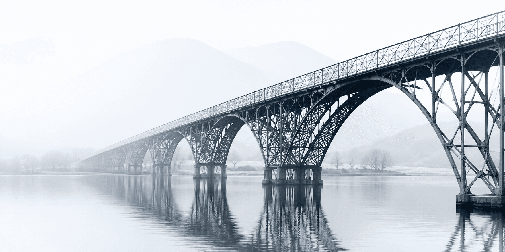 Steel arch bridge over misty water, a visual metaphor for Ironbridge's structured approach to risk